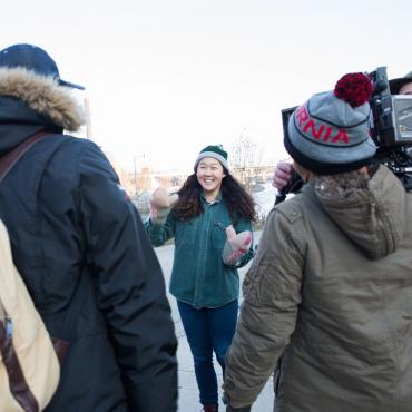 Naomi Ko is in the center of the photo surrounded by various crew members during the production of "Nice."