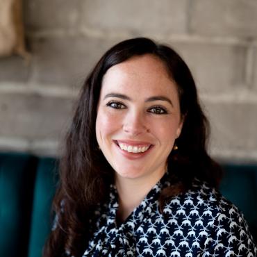 Victoria Blanco, a thirty-something Mexican-American writer, smiling at the camera.