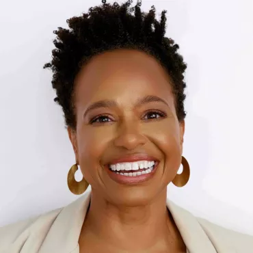 A headshot of Denise Greene against a neutral white background.