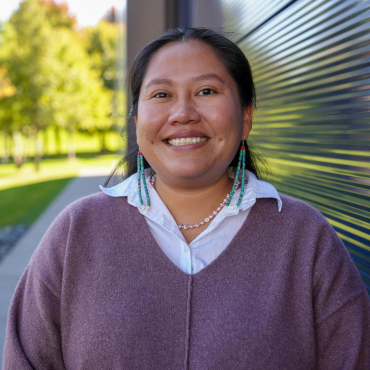 Blossom Johnson, a young Diné woman, smiling outside the Guthrie Theater.