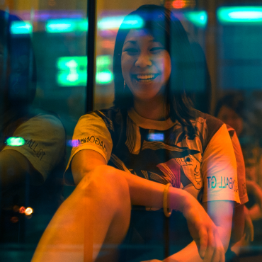 Oanh Vu, a 30-something Vietnamese American woman wearing a Dragon Ball Z shirt and smiliing at the camera.